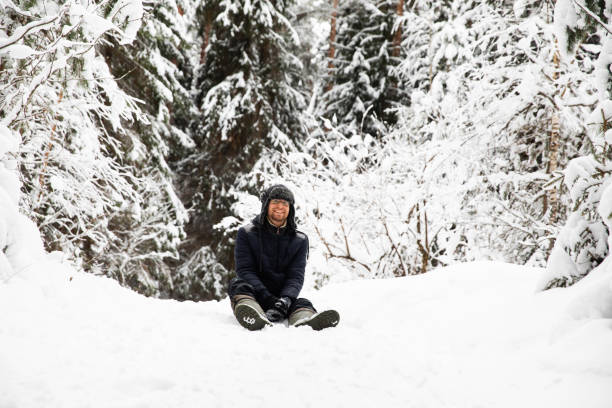 istock Man in fur winter hat with ear flaps smiling portrait 1095938736