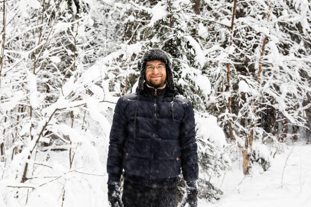 istock Man in fur winter hat with ear flaps smiling portrait 1095939586