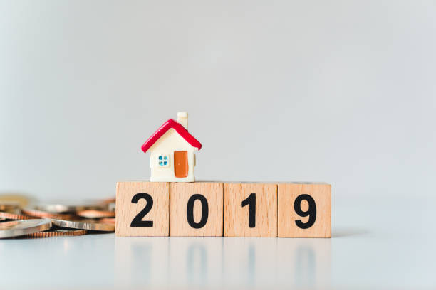istock Miniature house on wooden block year 2019 1095939946