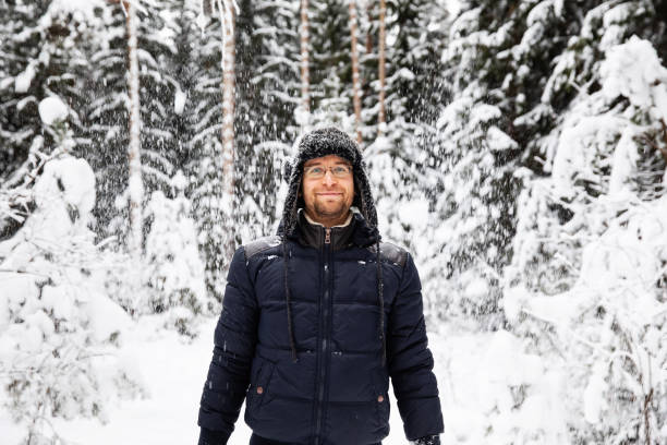 istock Man in fur winter hat with ear flaps smiling portrait 1095941836