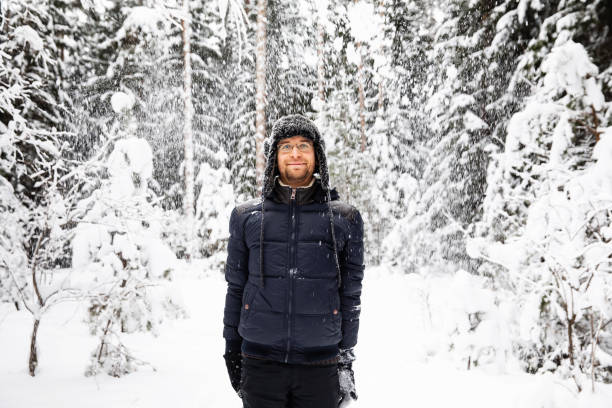 istock Man in fur winter hat with ear flaps smiling portrait 1095942146