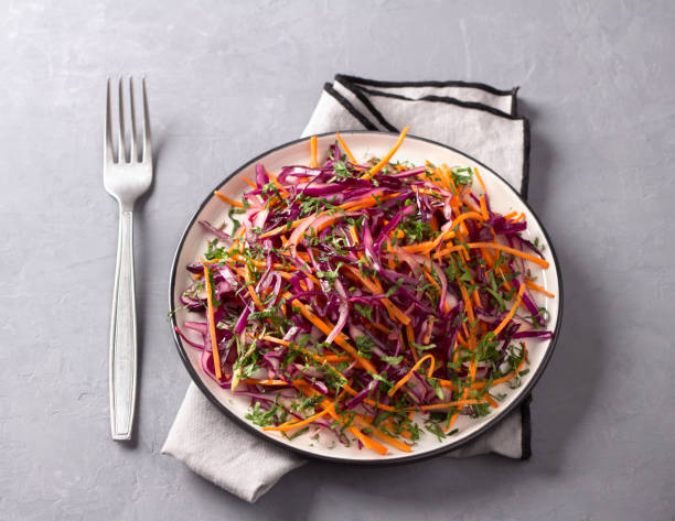 istock Red cabbage coleslaw salad with cumin and mustard sauce on gray background 1095943176