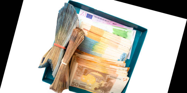 pile of euro cash notes in box isolated on white and black background with copy space