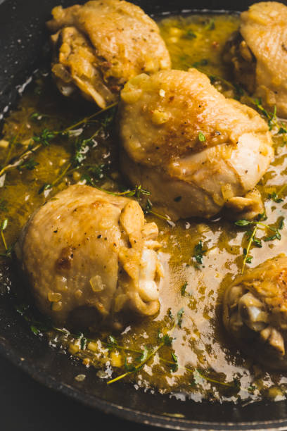 istock Roasted chicken in a pan with cream sauce and spices 1095947352