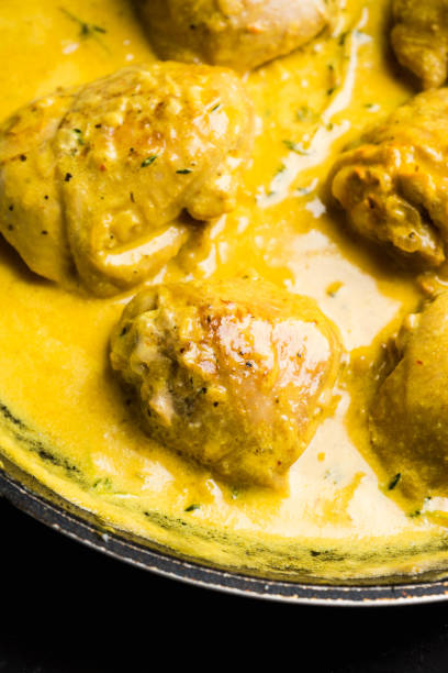 istock Roasted chicken in a pan with cream sauce and spices 1095947376