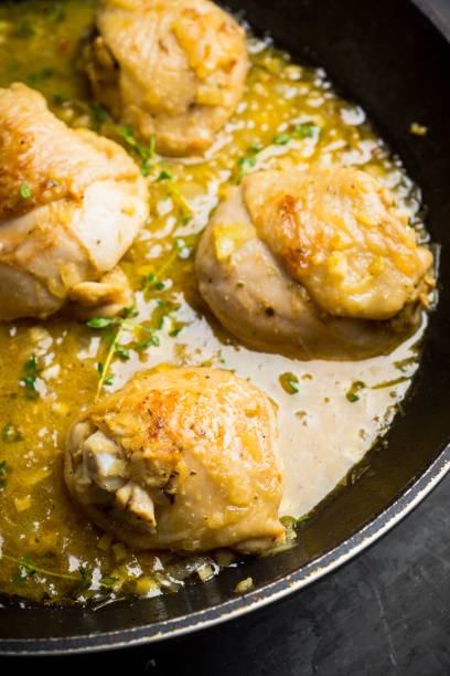 istock Roasted chicken in a pan with cream sauce and spices 1095947384