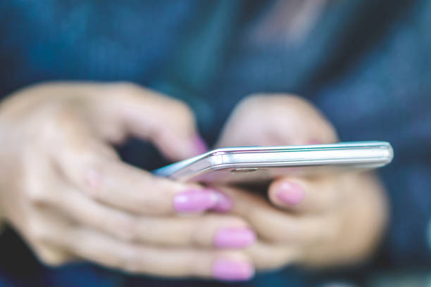 istock woman hand using smart phone surfing on internet 1095952688