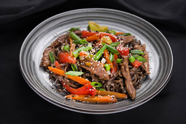 istock Wok pasta with meat, vegetables, asparagus and pepper 1095952712