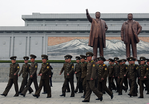 April 13, 2018. Mansudae Grand Monument, Pyongyang, North Korea.\nSoldiers visiting the huge statues of North Korean leaders. \nKim Il-Sung and Kim Jong-Il have special posters and monuments in different parts of the city. The most important of these monuments is the giant sculptures of North Korea's founding leader Kim Il-Sung and his son Kim Jong-Il. All tourists who come to visit the country have to come here and show their respects.