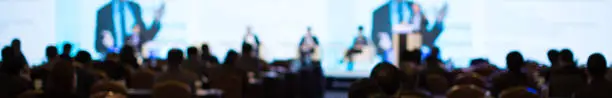 Photo of Panel on Stage during Discussion Event. Debate with Experts during Conference Seminar Presentation. Successful Executives and Entrepreneur Speakers and Presenters in Conference Hall Lecture Series.