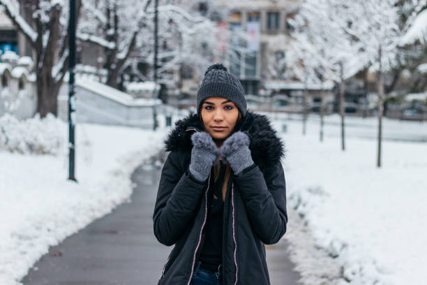 istock Woman walking in park covered with snow 1095958566