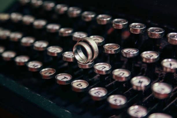 istock Wedding rings on the typewriter. Wedding rings placed on an ancient typewriter letter buttons. 1095958654