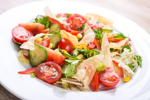 istock Fresh salad with tomato, cucumber, corn and chips 1095958830