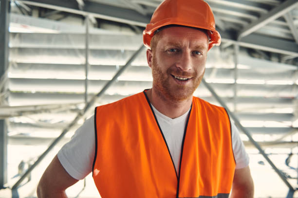 istock Worker man in helmet is locating in hangar 1095964782