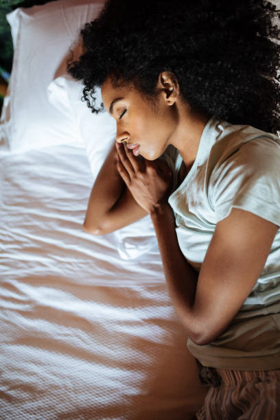 Beautiful black woman sleeping in bed stock photo