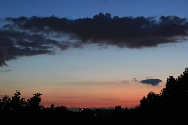istock Summer Sunset against Trees and Clouds 1095967516