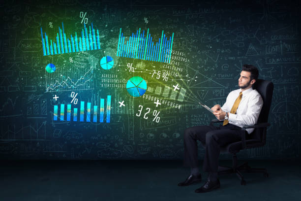 istock Businessman in office chair with tablet in hand and high tech graph charts 1095969434