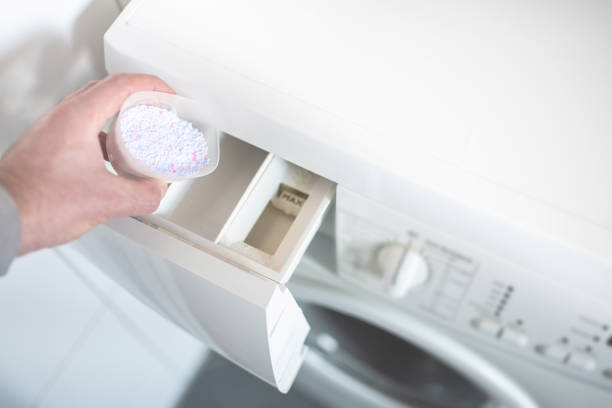 istock person using dosing aid to pout laundry detergent powder into washing machine 1095972386