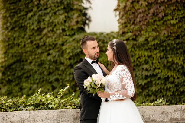 Photo of Beautiful wedding couple posing outdoor in nature