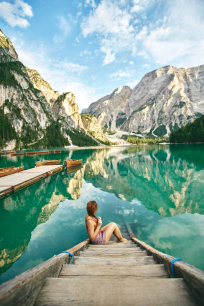 istock Young lady enjoy the nature at a beautiful lake . 1095978558