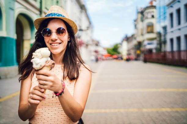 istock Young woman eating ice cream in a cone 1095978638