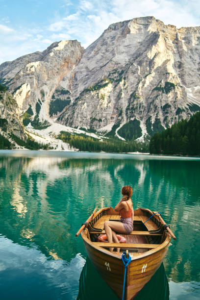 Young lady enjoy the nature at a beautiful lake . stock photo