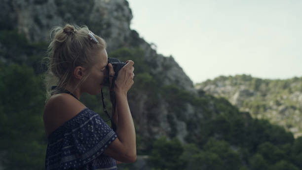istock Female photographer surrounded by mountains. Beautiful landscape 1095979272