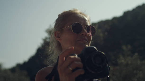 istock Female photographer surrounded by mountains. Beautiful landscape 1095979320