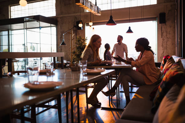 istock Two business women having coffee break in high-end restaurant 1095982156