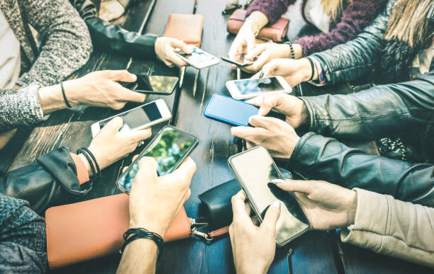 people hands having addicted fun together using smartphone - millenial sharing content on social media network with mobile smart phones - technology concept with millennials online on cellphone device - social media mobile phone facebook application software imagens e fotografias de stock