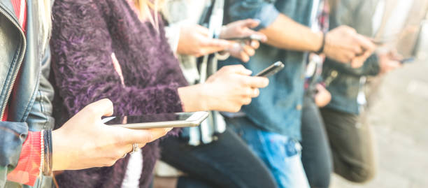 istock Multicultural friends group using smartphone at university college backyard break - People hands addicted by mobile smart phone - Technology concept with always connected millenials - Bright filter 1095982400