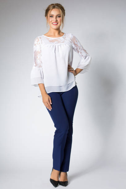 istock Beautiful blonde model posing in white shirt and blue pants 1095982886