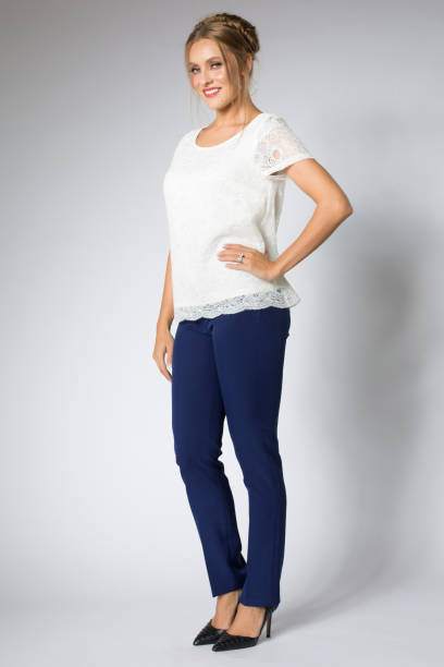 istock Beautiful blonde model posing in white shirt and blue pants 1095982926