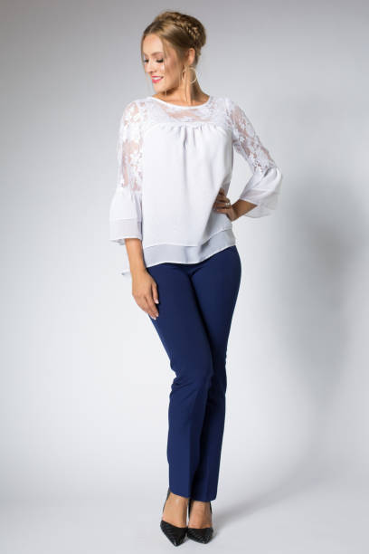istock Beautiful blonde model posing in white shirt and blue pants 1095982932