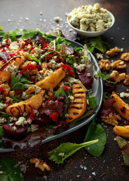 istock Grilled quince salad with baked and fresh grated beetroot, blue cheese, walnuts on rustic table 1095986044