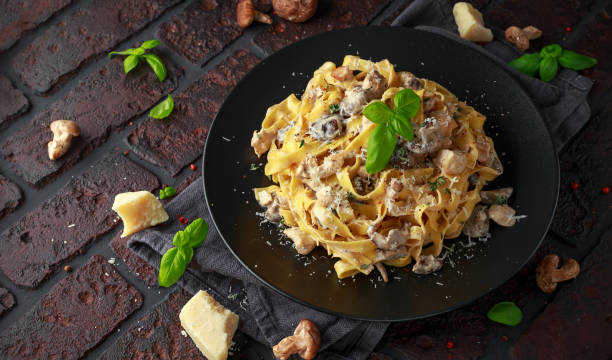 istock Pasta with shiitake mushrooms and chicken with herbs and cheese 1095986388
