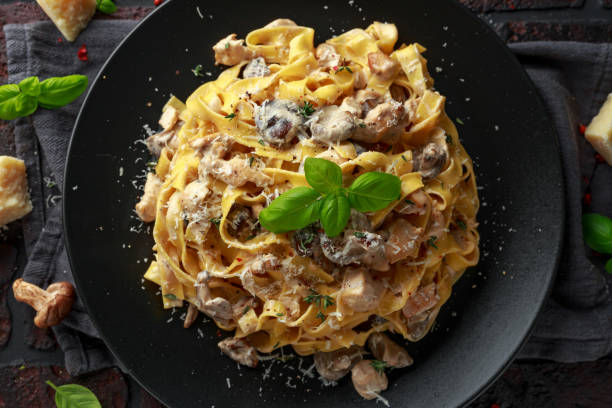 istock Pasta with shiitake mushrooms and chicken with herbs and cheese 1095986510
