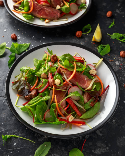 istock Spicy Beef Salad with Carrots, radish, bean sprouts, chilli, nuts and green mix 1095986514