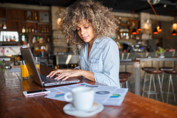 istock Focused young African woman working online in a cafe 1095986896