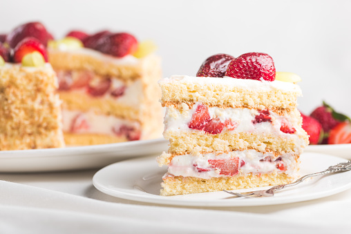 Sweet strawberry cake on a white tablecloth. delicious homemade food.