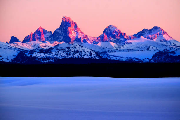 Sunset light with alpen glow on Tetons Tetons mountains rugged