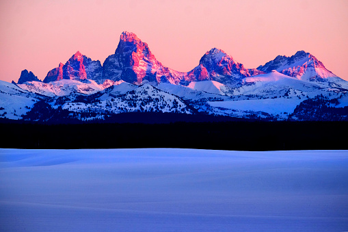 Sunset light with alpen glow on Tetons Tetons mountains rugged
