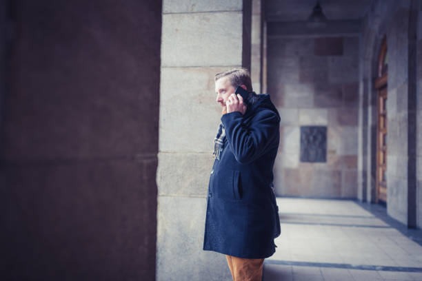 istock Ginger businessman using mobile phone outdoors 1095995472