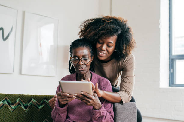 istock Smiling senior  and caregiver  with tablet 1095995622
