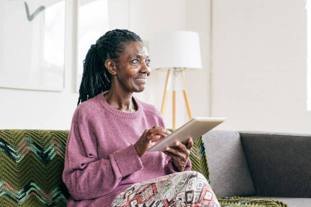 istock Smiling senior  and caregiver  with tablet 1095995624
