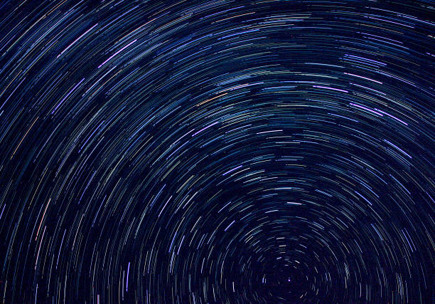 istock Night starry sky and star tracks 1095997498