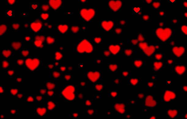 istock Red falling hearts on black background, blurred bokeh background, heart, holiday, love, black, delaminate 1095997828