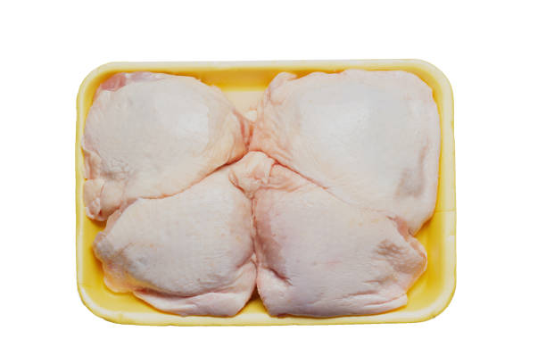 istock Pieces uncooked raw chicken meat thighs in plastic tray, isolated on white background 1095997940