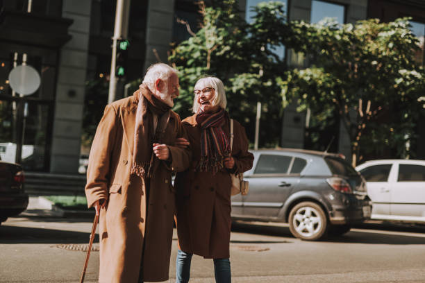 istock Happy elderly couple walking on the street side by side 1096001938