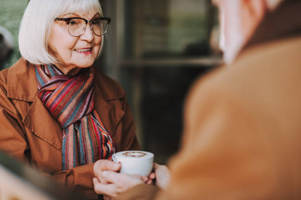 istock Old lady with hot drink spending time with husband in outdoor cafe 1096005974